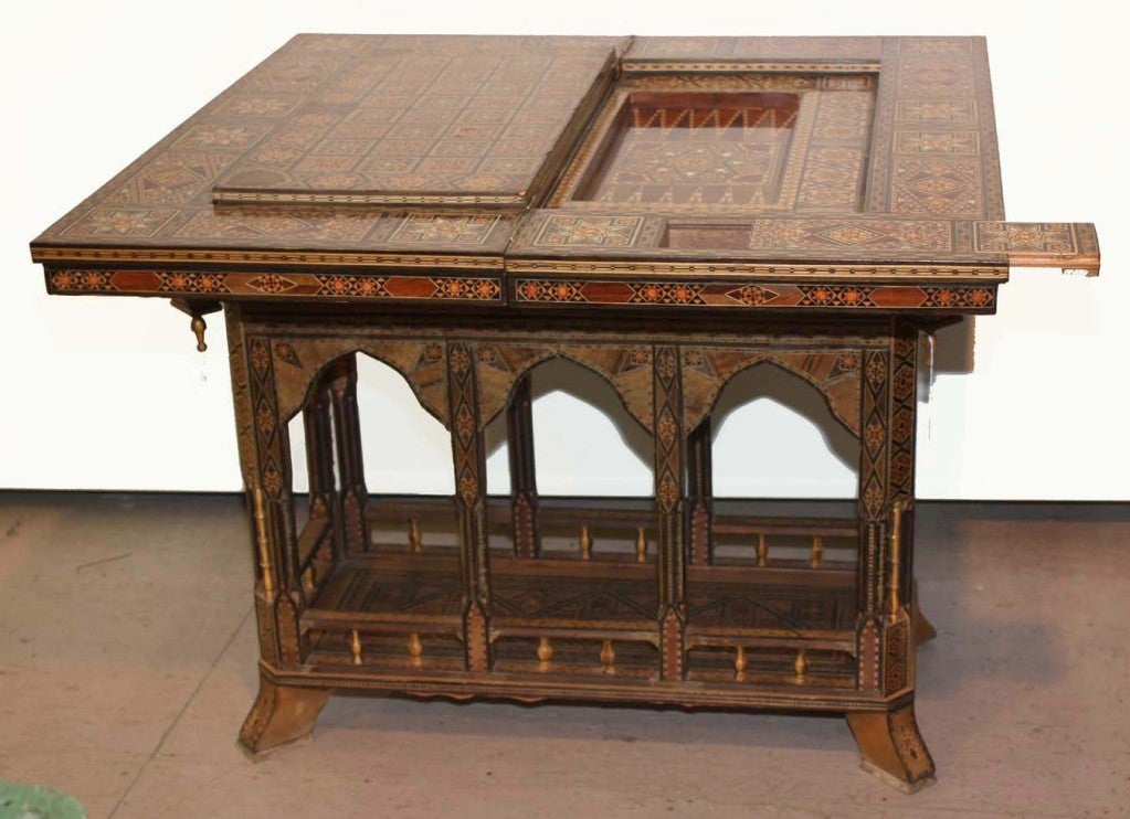 Syrian inlaid chess and backgammon foldover games table, fitted with boards for chess, backgammon, and cards. the swiveling top opens to reveal inset reversible removable board over backgammon surface; diagonally opposing sides with sliding