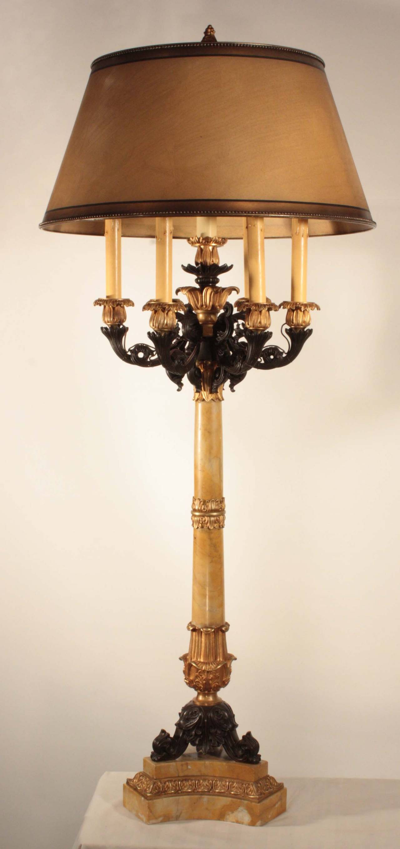 Pair of impressive French Restauration candelabra, now mounted as lamps, each seven-light gilt and oxidized bronze candelabrum mounted on a Sienna marble column supported on a gilt and oxidized trefoil base.

These are a happy union of Sienna marble