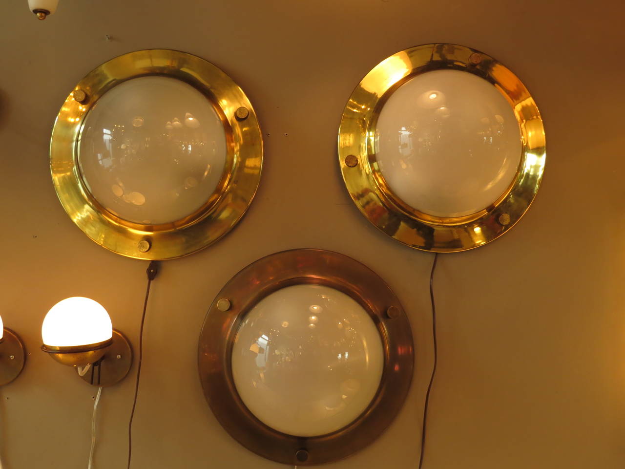 Brass frame and half-globe in glass frosted inside.
Beautiful brass details. Can be used as wall sconces or flush-mount ceiling fixtures.