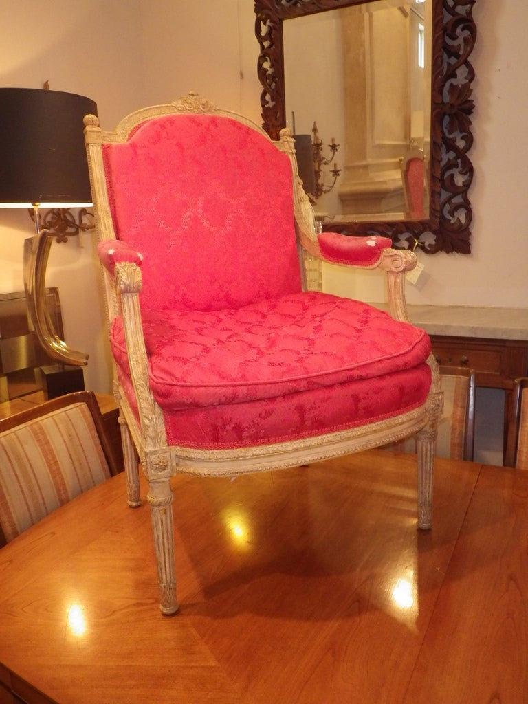 Very elegant pair of hand-carved, Louis XVI chairs. Detailed wood frame with red upholstery.