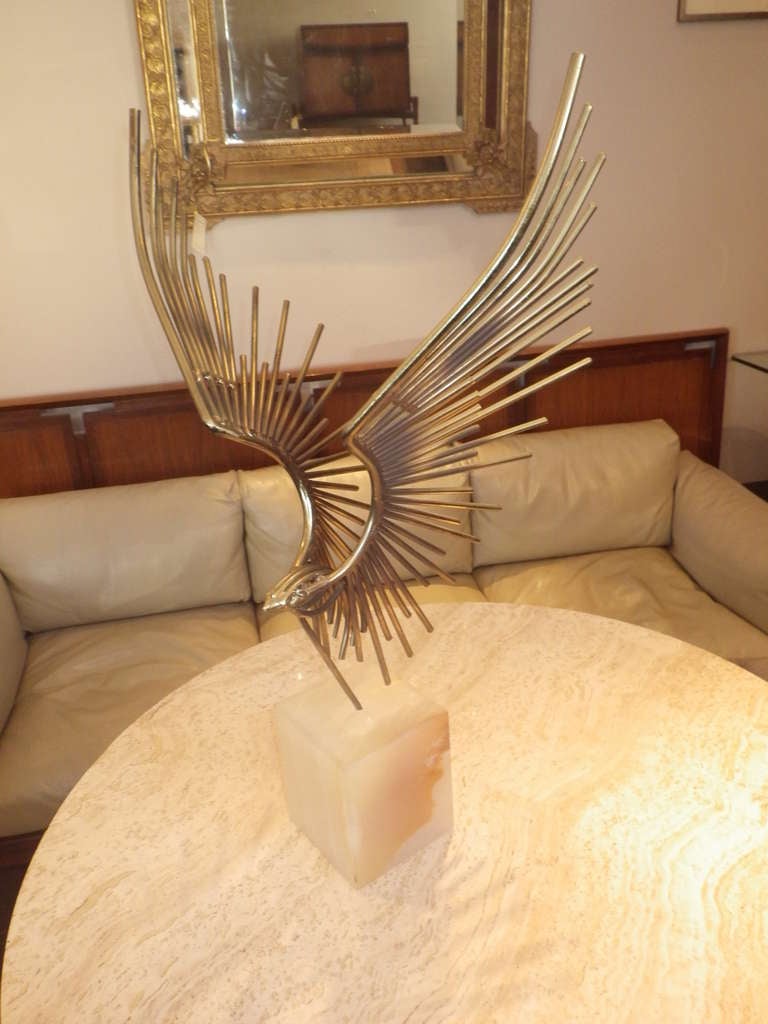 Very elegant statue by Curtis Jere. Marble base with stainless steel bird.