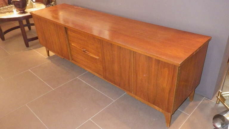 Very elegant low credenza by Ico Parisi. Solid Walnut.
Two drawers in the middle and double-jointed swing doors at the ends. 