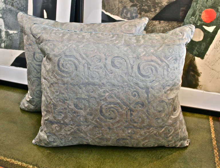 Pair of Fortuny pillows created with vintage Fortuny fabric in the Maori pattern and dating to the 1950's, shortly after the death of Mariano Fortuny. The fabric has acquired a soft patina brining it to an almost ice blue tone. The pillows are