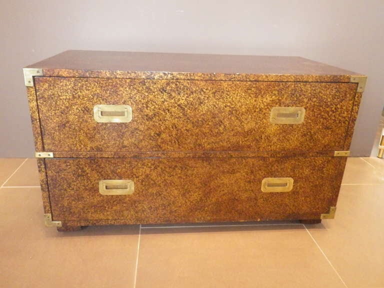 Very elegant chest with two mid-sized drawers and brass pulls. Handle on both sides and corner decorations are also made of brass. 