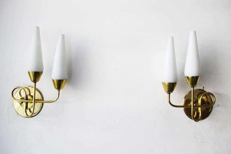 Beautiful pair of Italian sconces made of brass and glass.