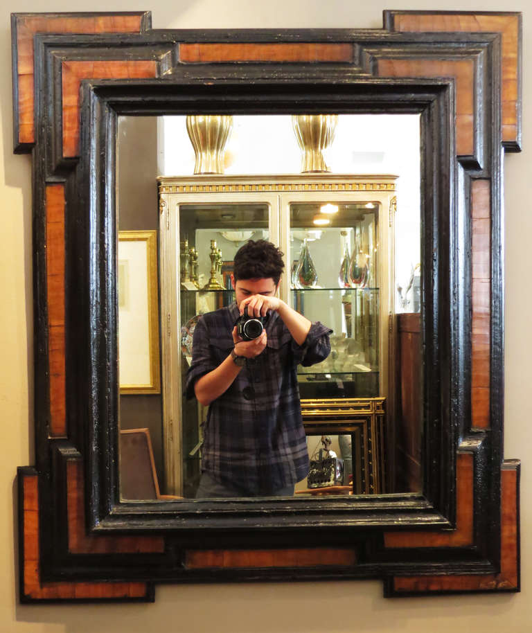 Exceptional Flemish mirror hailing from the late 1600s. This piece has the original landing on the frame and restorations to the moldings.