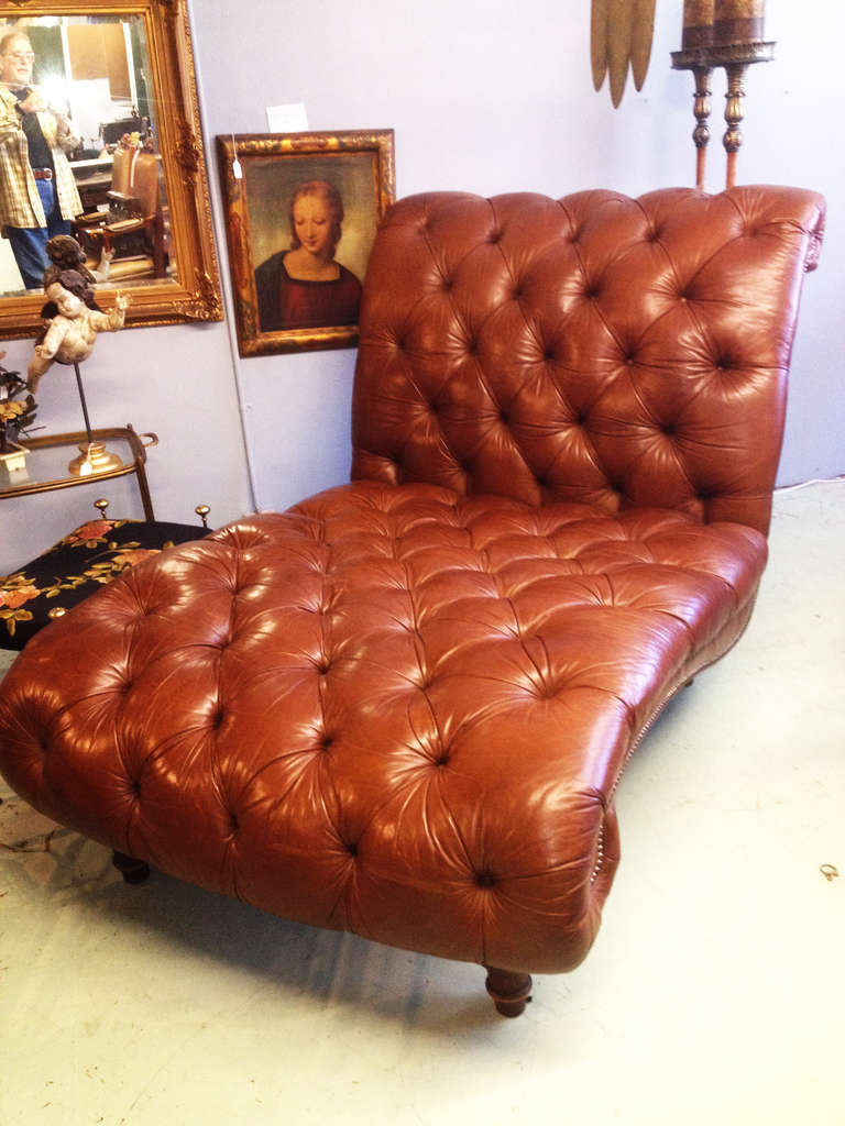 Over-sized tufted chaise-- a perfect example of the English Chesterfield style. Tan leather and studded stitching.

Disclaimer: Please contact us in advance if you would like to view this item at our showroom. We have a large inventory and many of