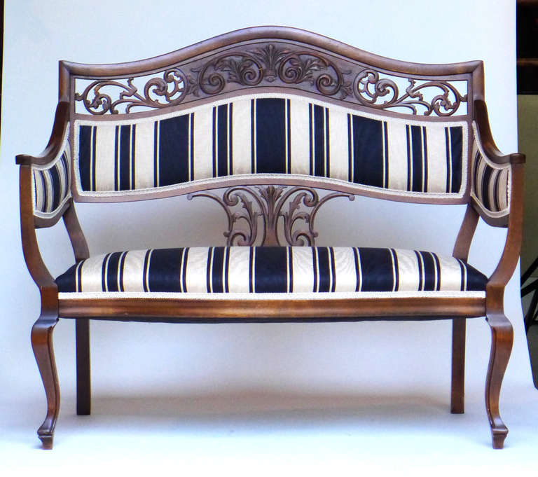 Early 20th c. carved bench/settee made of walnut. Upholstered in fine striped satin.

Disclaimer: Please contact us in advance if you would like to view this item at our showroom. We have a large inventory and many of our items are stored at our