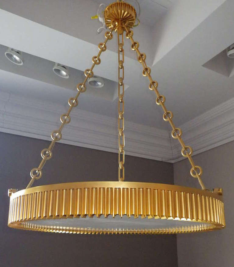 Beautiful, art deco style, very heavy pendant chandeliers. The gold plated, bronze body has been exquisitely made. The relief pattern on the pendant matches the pattern on the ceiling mount. There is an inset, authentic alabaster that covers the