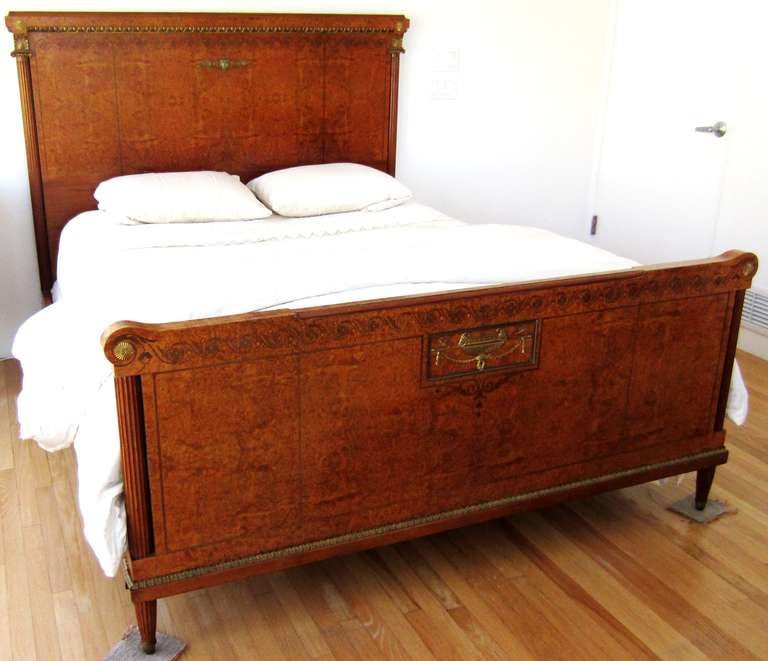 Beautiful Louis XVI period piece made of Burled Walnut. This bed is in excellent restored condition. Also has decorative bronze inlays and hand-carved column legs. 

Note: This piece is at our warehouse for the moment. Please call and schedule a