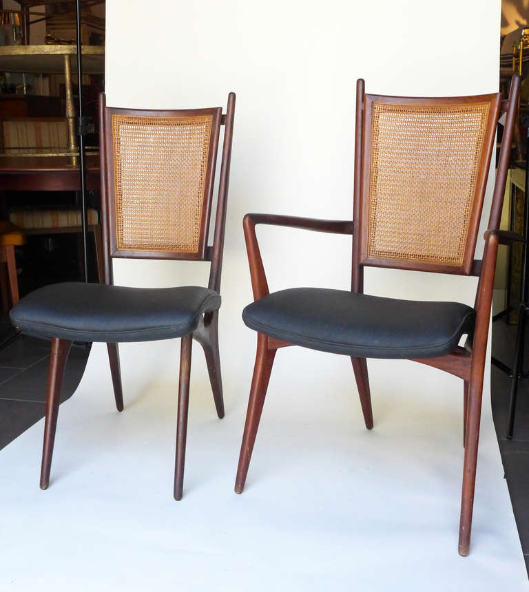 Set of 6 dining chairs by Grosfeld House. There are 2 arm chairs and 4 chairs without arms. All the chairs have cane backs and vinyl upholstered seats.

The cane on some of the chairs is in need of some repair.