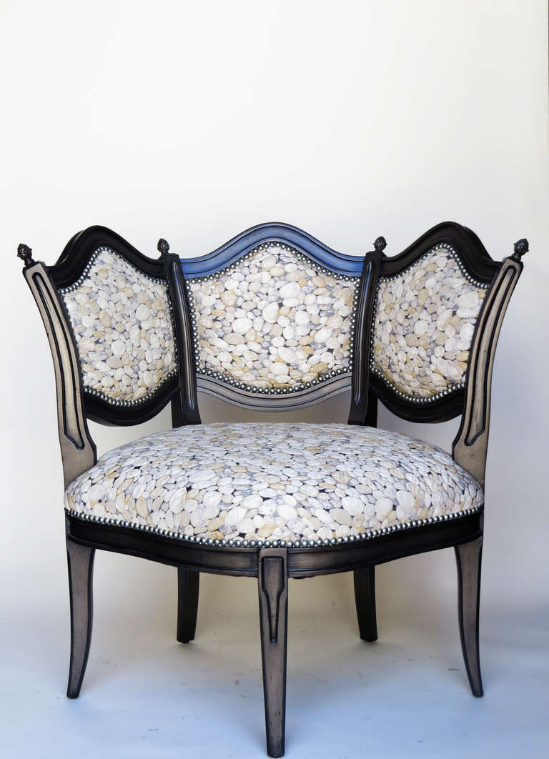 Pair of Hollywood Regency style corner/side chairs with black lacquered frames and pebbled upholstery.