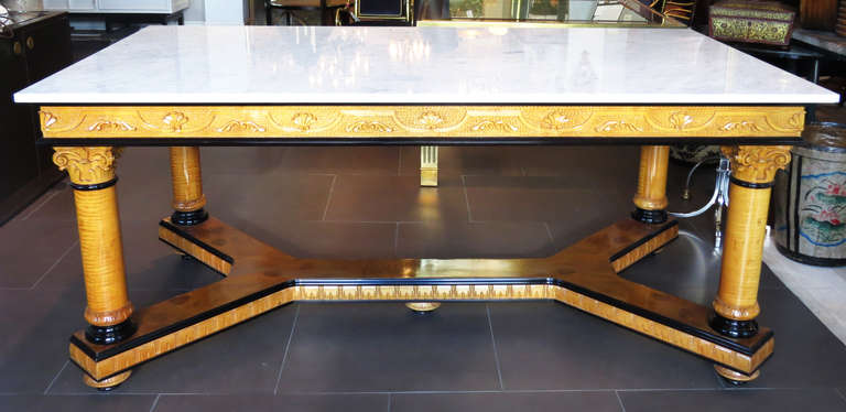 Biedermier foyer table made of carved wood and a heavy marble top.