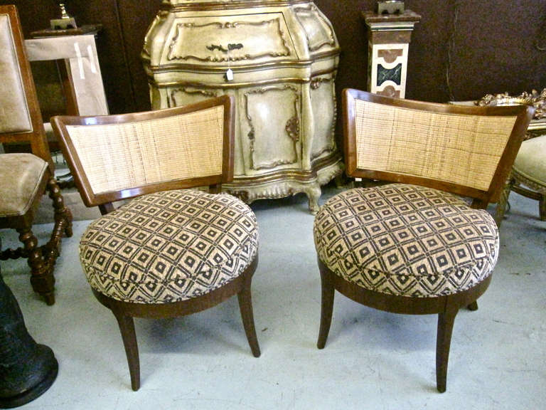 Pair of c. late 1950's solid and veneer mahogany with framed caned back pull-up chairs in the style of Billy Haines. The quality of these chairs is of the highest level and the original condition of the frames is excellent. The modified klismos form