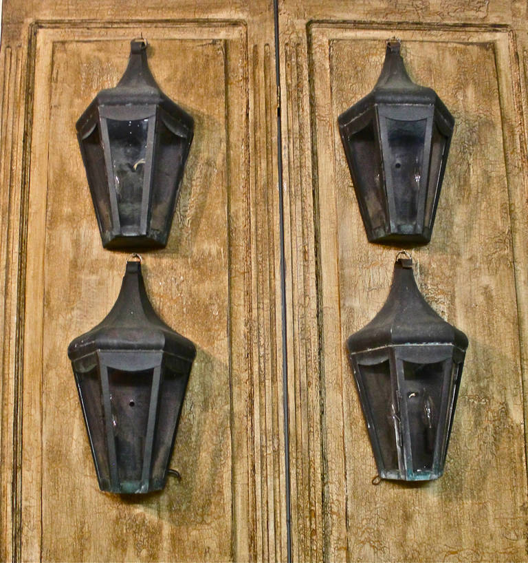 This is a great set of 18th to 19th Century style copper wall lanterns that date to last half of the 20th century. The wall lanterns have been electrified and are marked with Underwriter's Laboratories' labels. All of the lanterns are in excellent