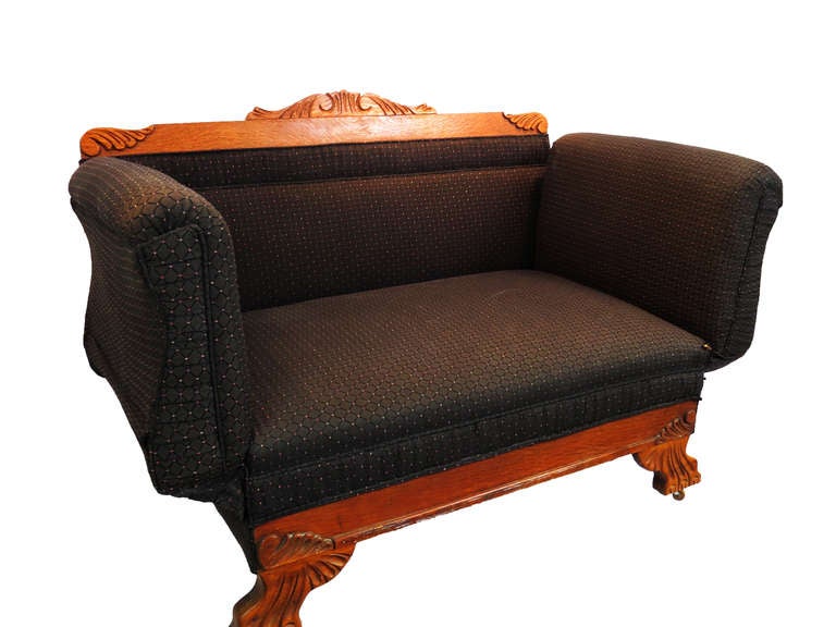 This is a very unique early 20th century sofa with arms that adjust to desired height.