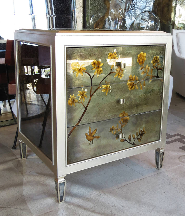 Pair of verre églomisé chests.