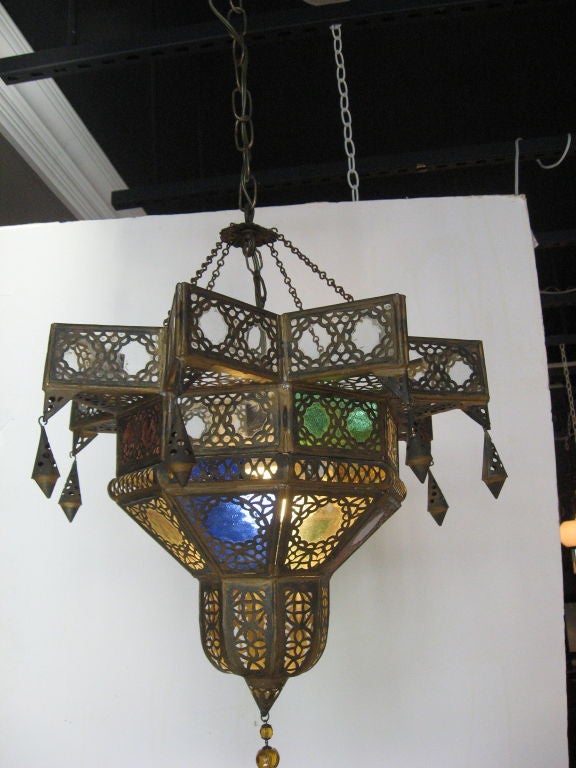 Circa 1930's Moroccan chandelier with hand tooled brass filigree with blue,green, yellow stained glass.  Amber 