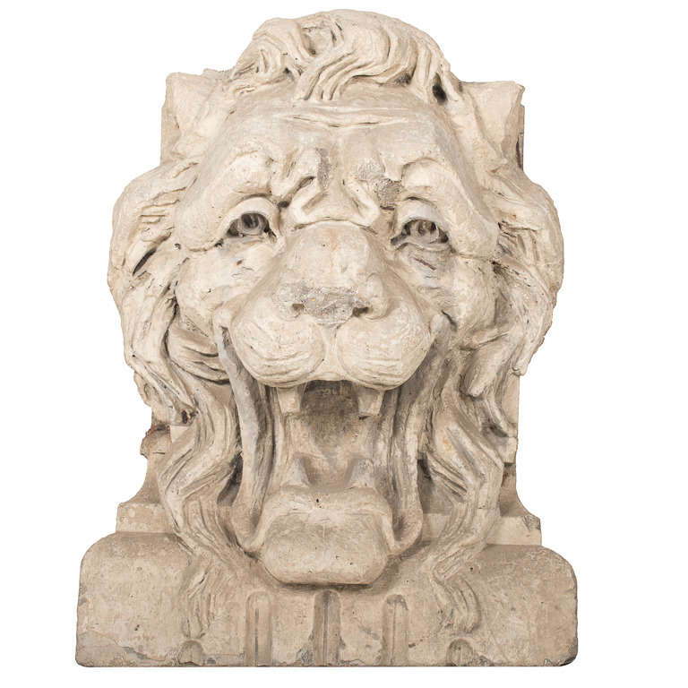 Pair of carved stone lion heads pulled from the facade of a pre-haussmann parisian building. Beautiful large scale intricate carvings with concave backs.