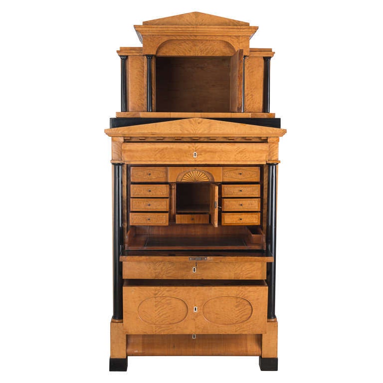 Fall front secretaire with a pair of free-standing columns on the exterior. It has an architectural interior with a central door flanked by a pair of columns supporting a drawer with balustrade of finely turned wooden banisters.