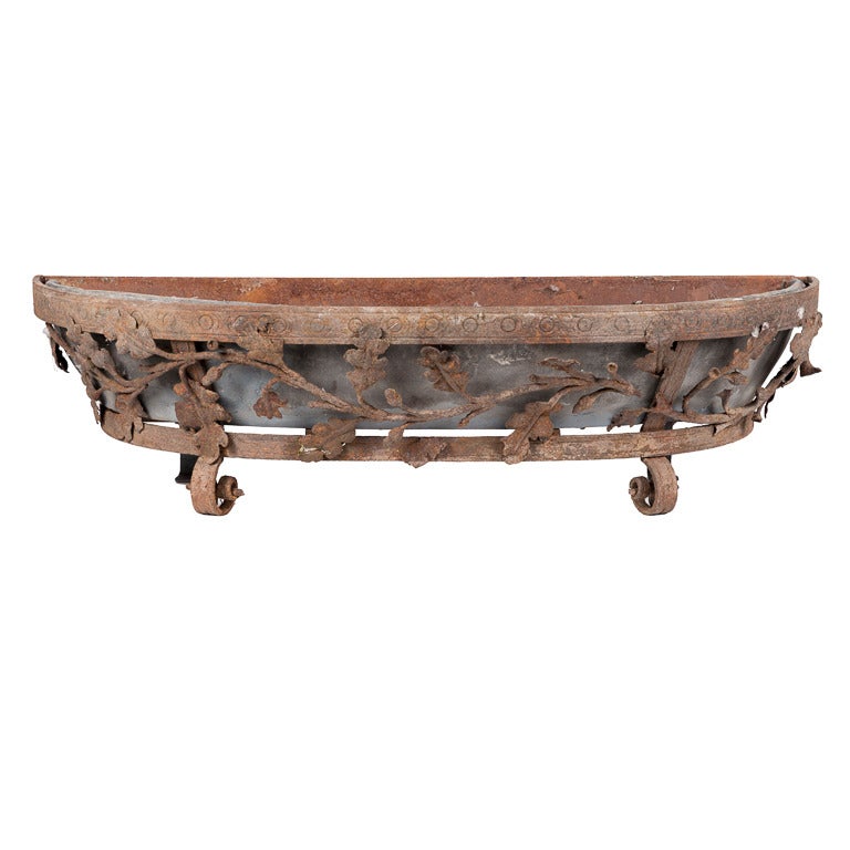 Large pair of exceptional 17th century hand-wrought iron planter boxes with grape vine detail throughout and scrolled feet. Beautiful original patination with zinc planter box inserts.