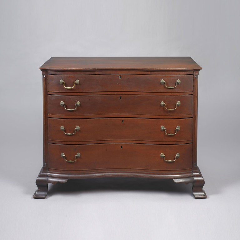 Connecticut, ca. 1770.
Cherry, pine and poplar secondary woods
The chest has an undermolded top above four graduated reverse-serpentine drawer fronts flanked by quarter columns. The case is blocked at the ends which conforms to the ogee bracket