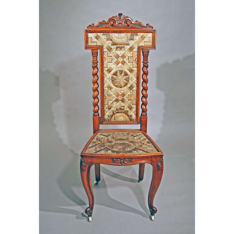 Mahogany side chair with carved crest inset with a porcupine quillwork panel flanked by barley twist spiles. A quillwork seat rests on legs supported by a trapezoidal stretcher. Four cabriole feet in the French manner end on porcelain casters.

It