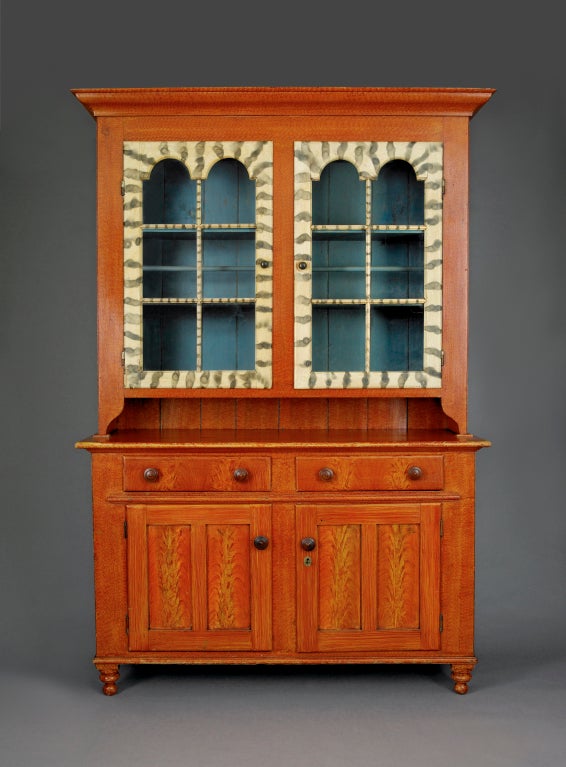 Paint-decorated step-back cupboard with tomb-stone glass panel doors Pennsylvania, circa 1820-1830. Original turned pulls. An extraordinary survivor of time. The cupboard's proportions and incredible paint decoration make it highly desirable. The