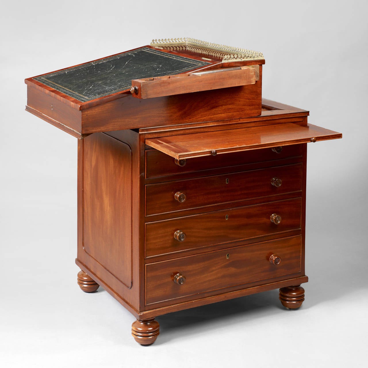 English, circa 1820-1830.
Figured mahogany, leather embossed writing surface.
Condition: Excellent condition, some wear to leather writing surface.
These fully developed mechanical desks became popular during the Regency period. This example is