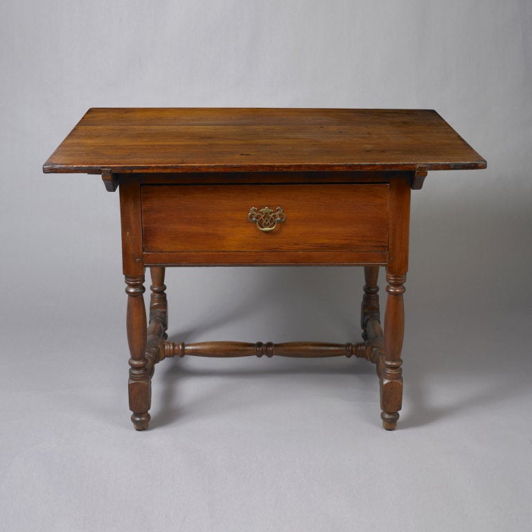 Queen Anne one-drawer tavern table, Pennsylvania, circa 1730-1750. The size and presence of the piece are fairly indicative to its origin. The cleeted top which is removable, rests above a deep central drawer. The turned legs and the