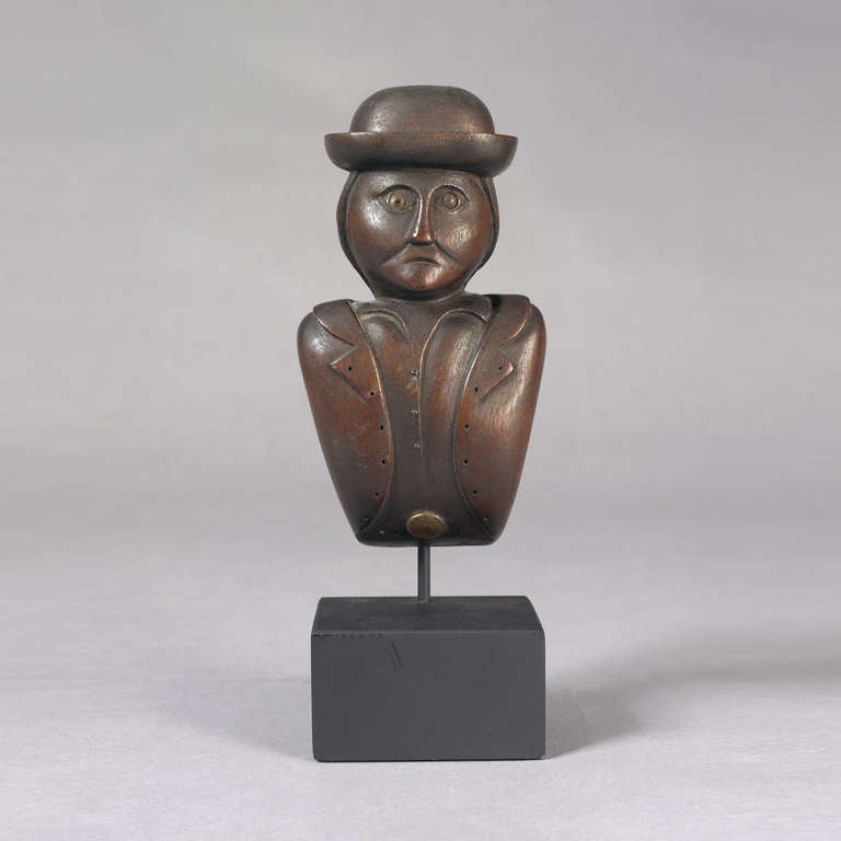 American, probably New England, ca. 1820-1850.
Mahogany, brass buttons
A wonderful stylized half round carved full length figure of a man with delineated hat, facial features with inset glass eyes, shirt and jacket with metal tack buttons.