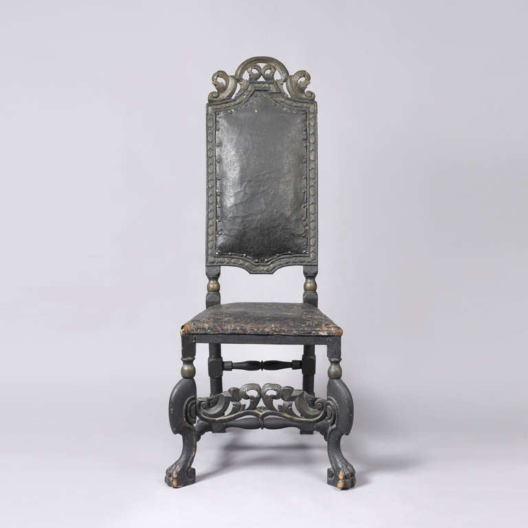 Northern European, ca. 1680-1710.
Having a carved pierced crest above an upholstered back flanked by carved stiles with a trapezoid upholstered seat frame supported by carved legs and a carved pierced front panel joined by block and turned