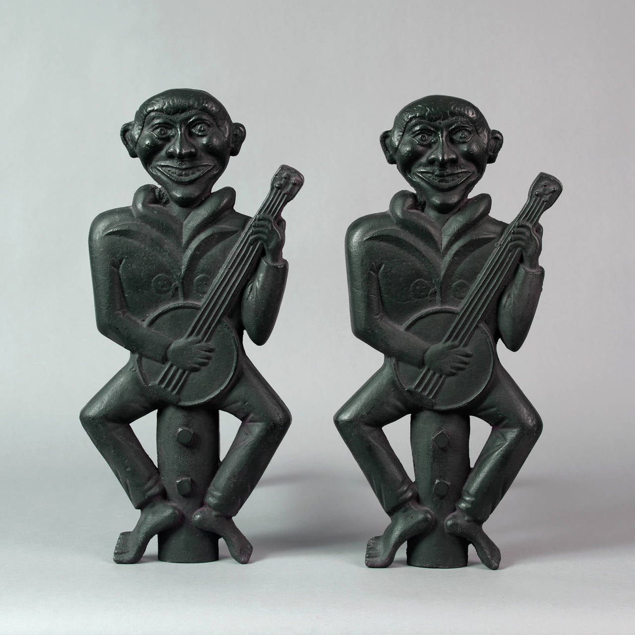 American, ca. 1870.
Cast iron painted black
Condition: Finely cast, replaced dogs
This pair of figural form andirons of two gentlemen,perhaps African-American, playing banjos are quite stylized and whimsical.