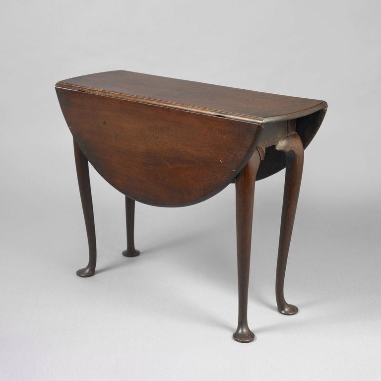 New England, probably Massachusetts, ca. 1750.
Mahogany, maple and chestnut secondary woods
In a desirable diminutive size, the leafs open to a round top supported by graceful cabriole legs ending on disc-form pad feet. 
Condition: Retains an old