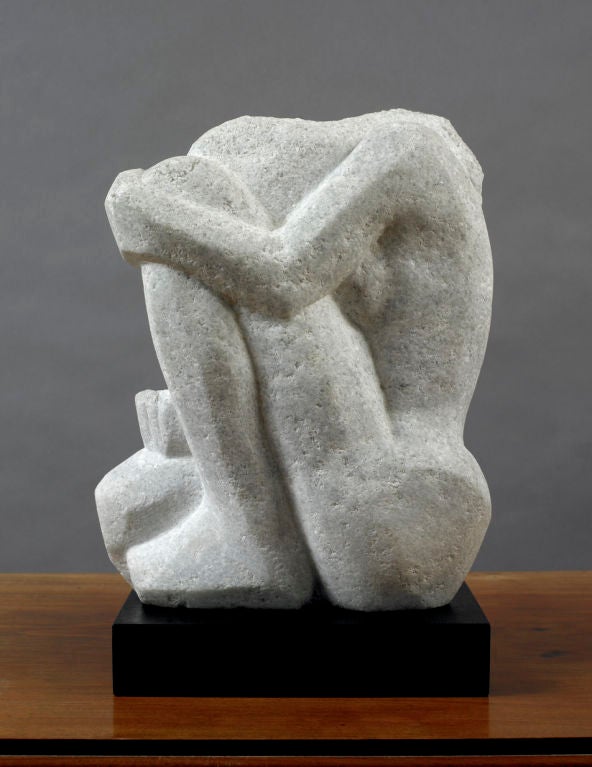 Sculpture of a Woman Kneeling, American, probably New York ca. 1930.<br />
The juxtaposition of the figure kneeling with her head tucked behind her leg is carved in an abstract manner.  Note the curvilinear lines of the form against the hard-edge