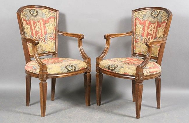 Pair of Walnut Neoclassical Open Arm Chairs,<br />
Circa 1940,<br />
upholstered in Clarence House 