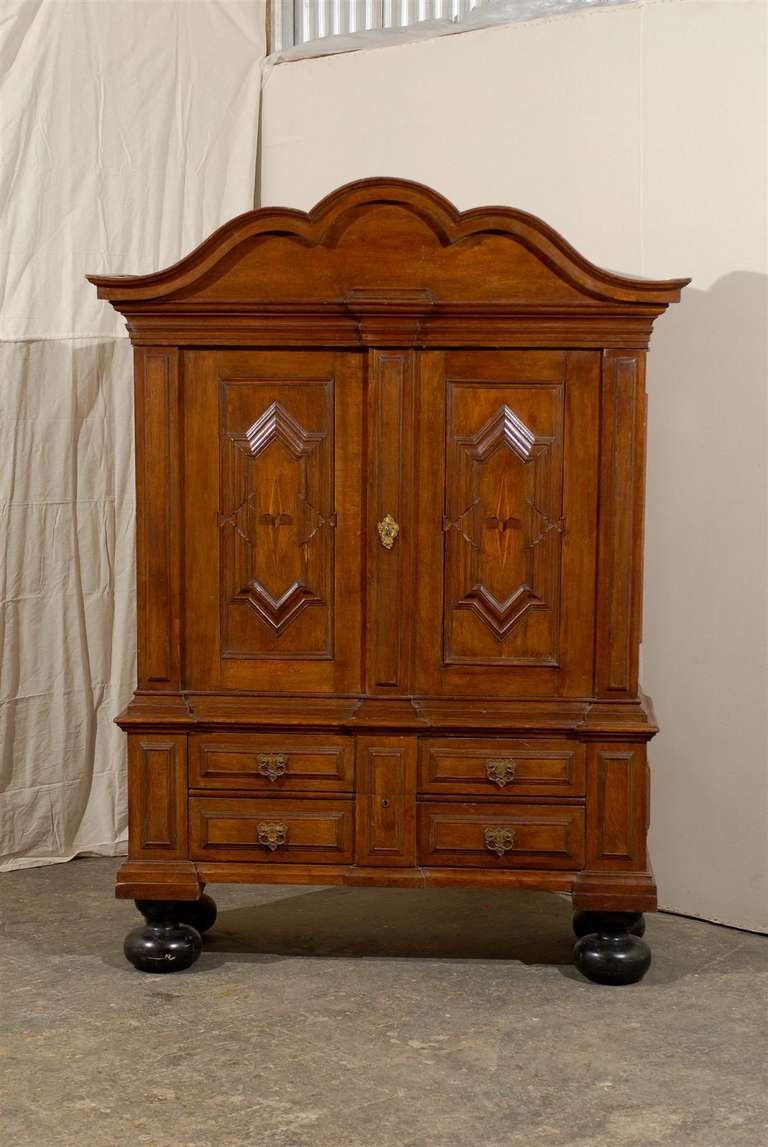 A Swedish late 18th - early 19th century wooden cabinet, Perfect depiction of the transition between Baroque to Rococo period. This Swedish wooden linen press features two Doors over two drawers, topped with a nicely carved pediment. This cabinet is