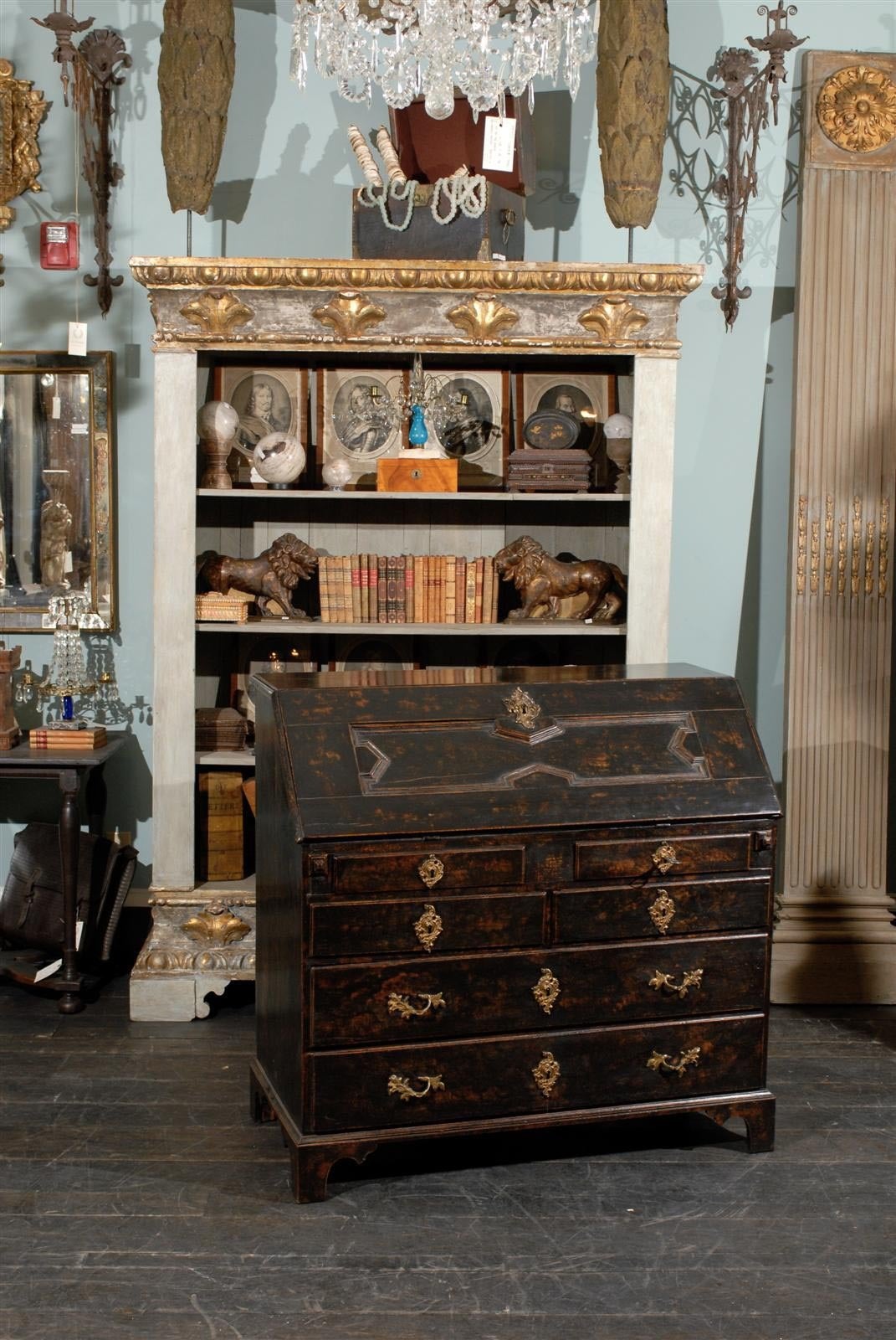 A Swedish period Baroque black with brown undertone slant-front desk from the early 18th century on straight bracket feet. Six lower drawers and multiple drawers and central door in the desk part.