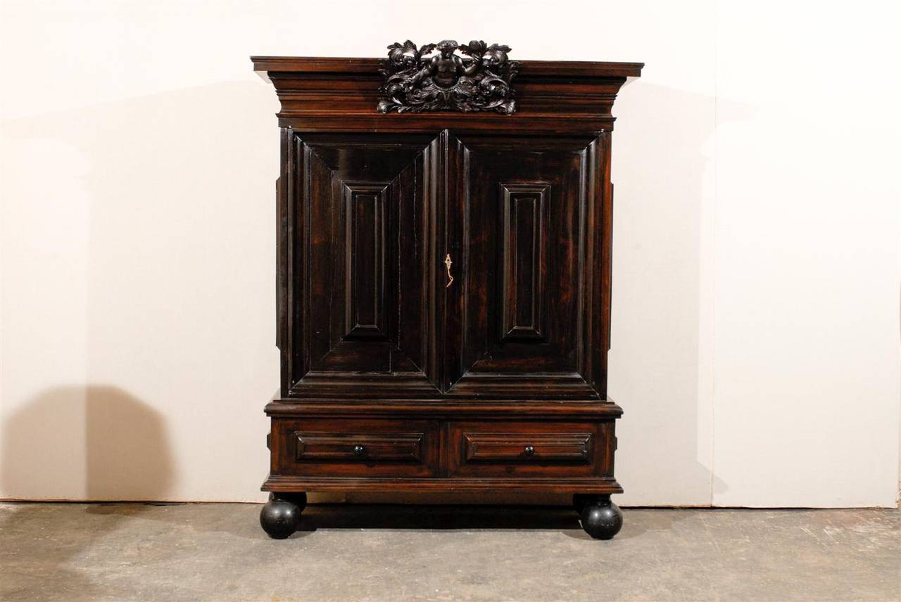 A large size late 17th, early 18th century Swedish period Baroque cabinet of ebonized rosewood. This exquisite Swedish cabinet most likely features a depiction of the Virtue prudence at the crest. This rosewood cabinet is made of two doors with