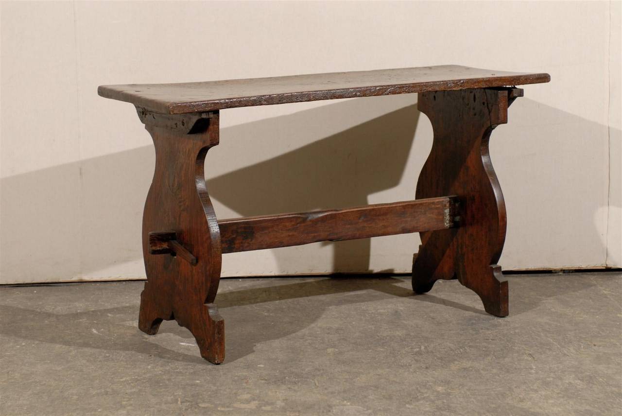 An 18th century Italian wooden console trestle table or desk. Beautifully shaped sides.