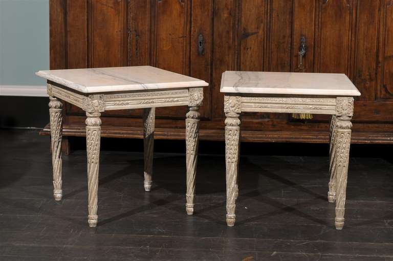 A pair of Italian marble-top painted wood side tables from Italy. Nice carved wood legs and skirt.