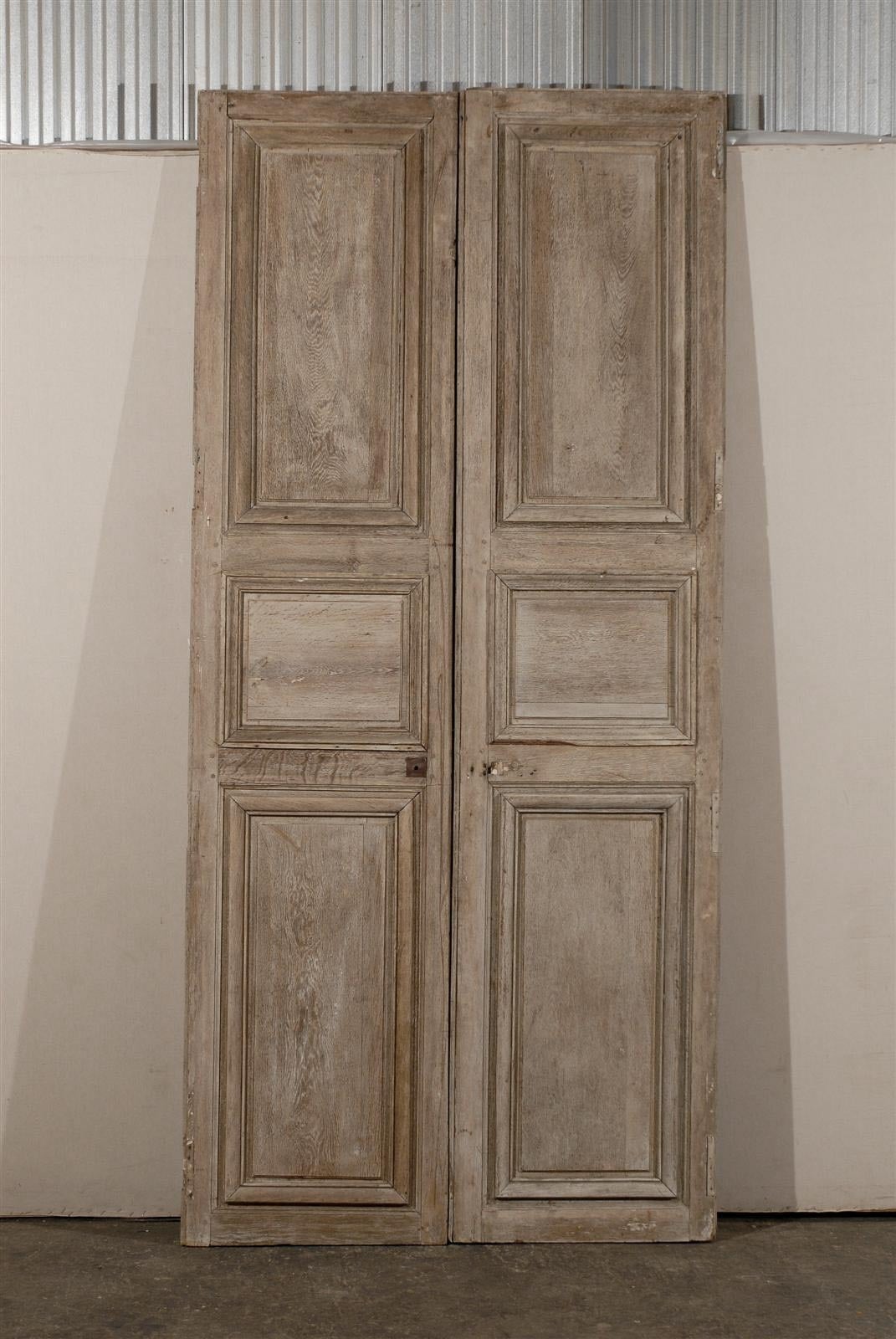 A pair of French 19th century wooden doors made of oakwood. Clean, elegant lines. Would be perfect on a rail.