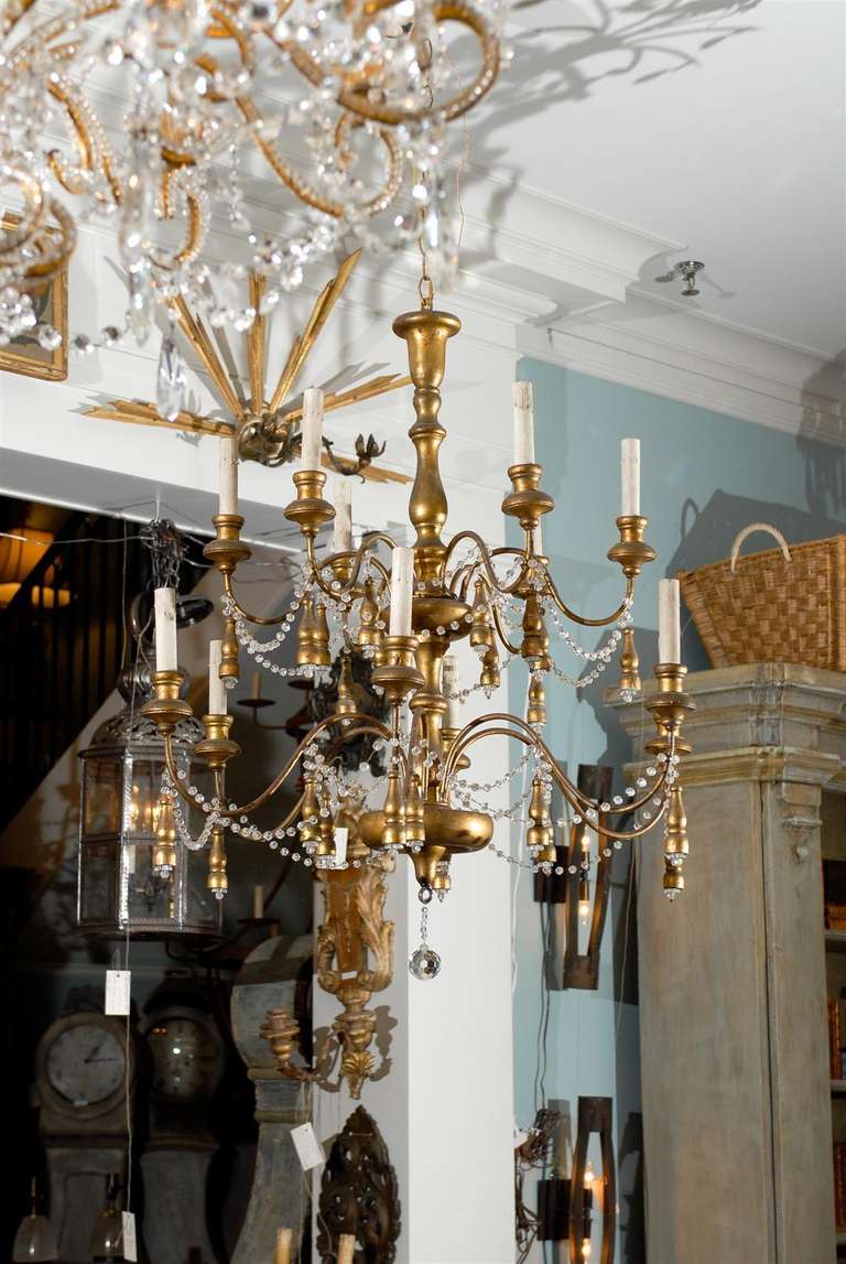 A French vintage 12 light gilded wood chandelier, rewired for the US.