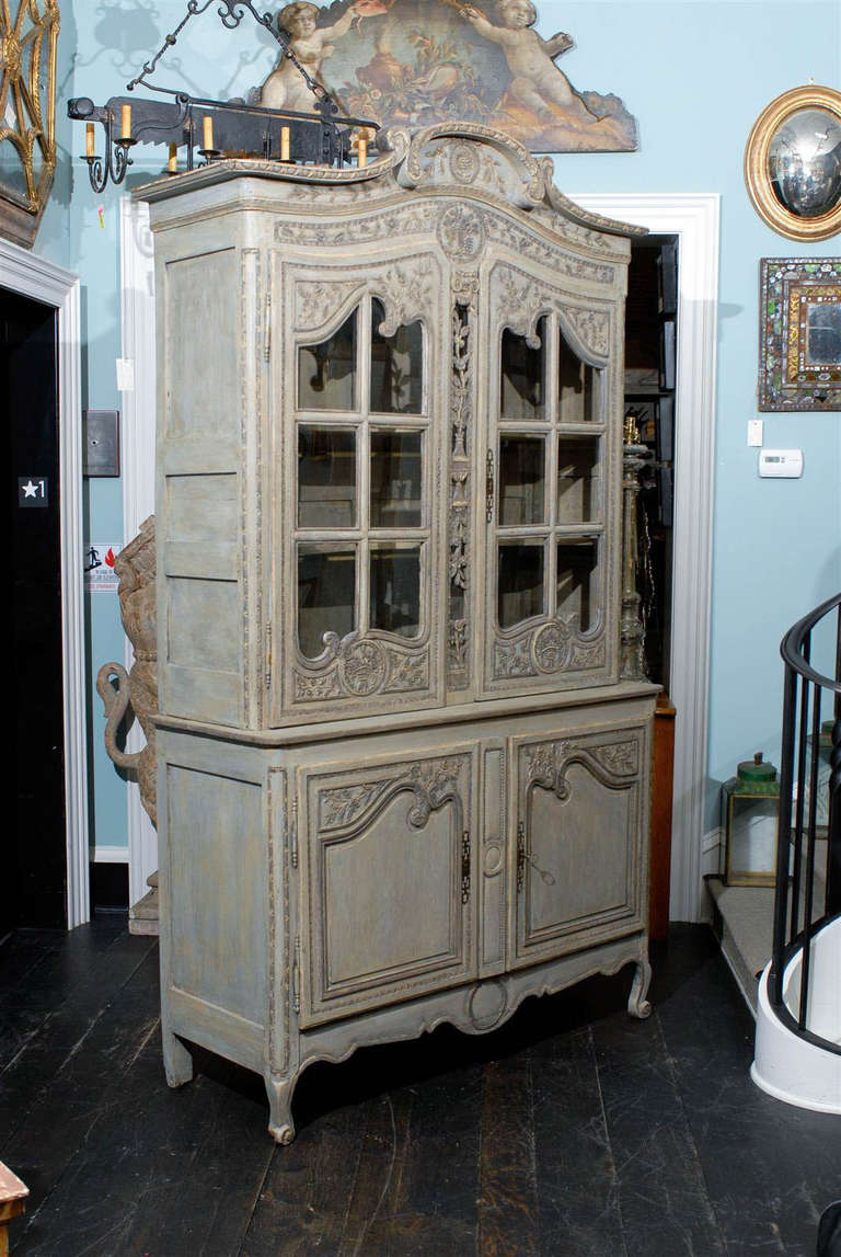 A French Early 19th Century Painted Oak Buffet à Deux-Corps with Glass Doors, Wonderful Pediment, Carved Floral Details and Panels and Scroll Feet.