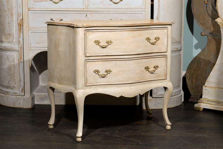 An Italian faux marble top custom painted chest with two drawers and cabriole legs.