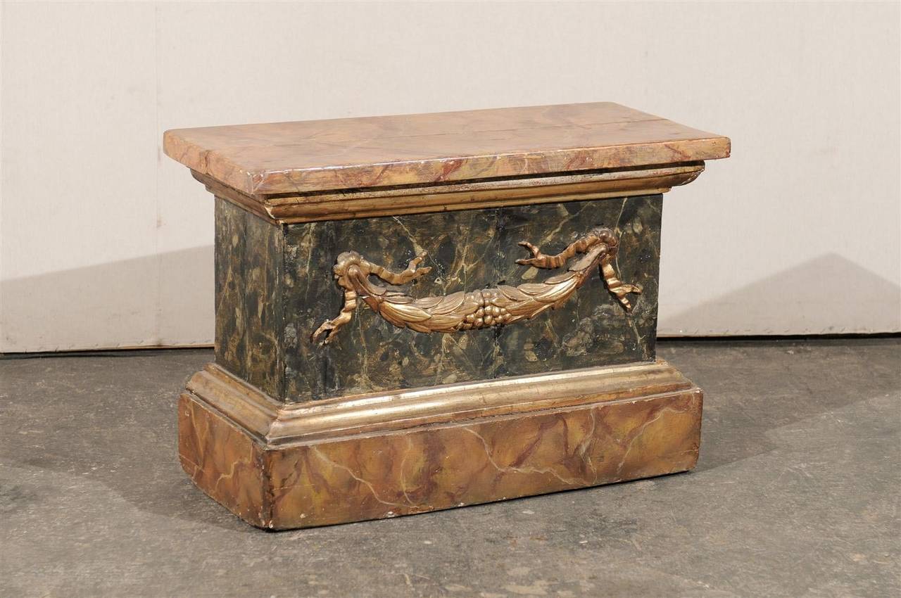 An Italian 18th century faux-marble pedestal with gilded swag ornament.