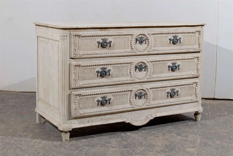 A French Early 19th Century Bleached Oak Three-Drawer Chest, Richly Carved with Rounded Fluted Side Posts and Lovely Hardware.