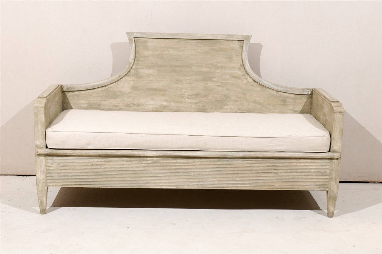 A pair of Swedish period Gustavian painted wood, upholstered sofas / benches from the early 19th century with wonderful high back pediment, fluted front, tapered legs and custom cushions.