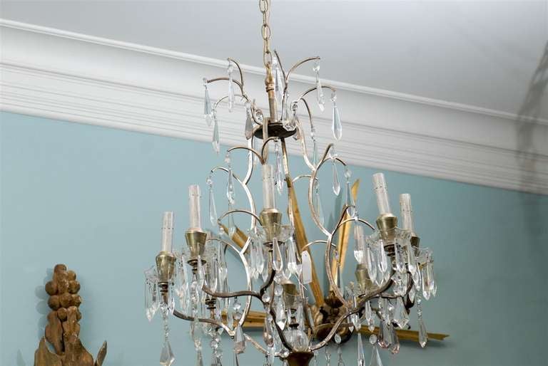 A Swedish eight-light vintage crystal chandelier from the mid-20th century. This Swedish crystal chandelier is going to seduce you with its simple and timeless elegance. The faceted crystals alternate clear ones with a few with a translucent purple