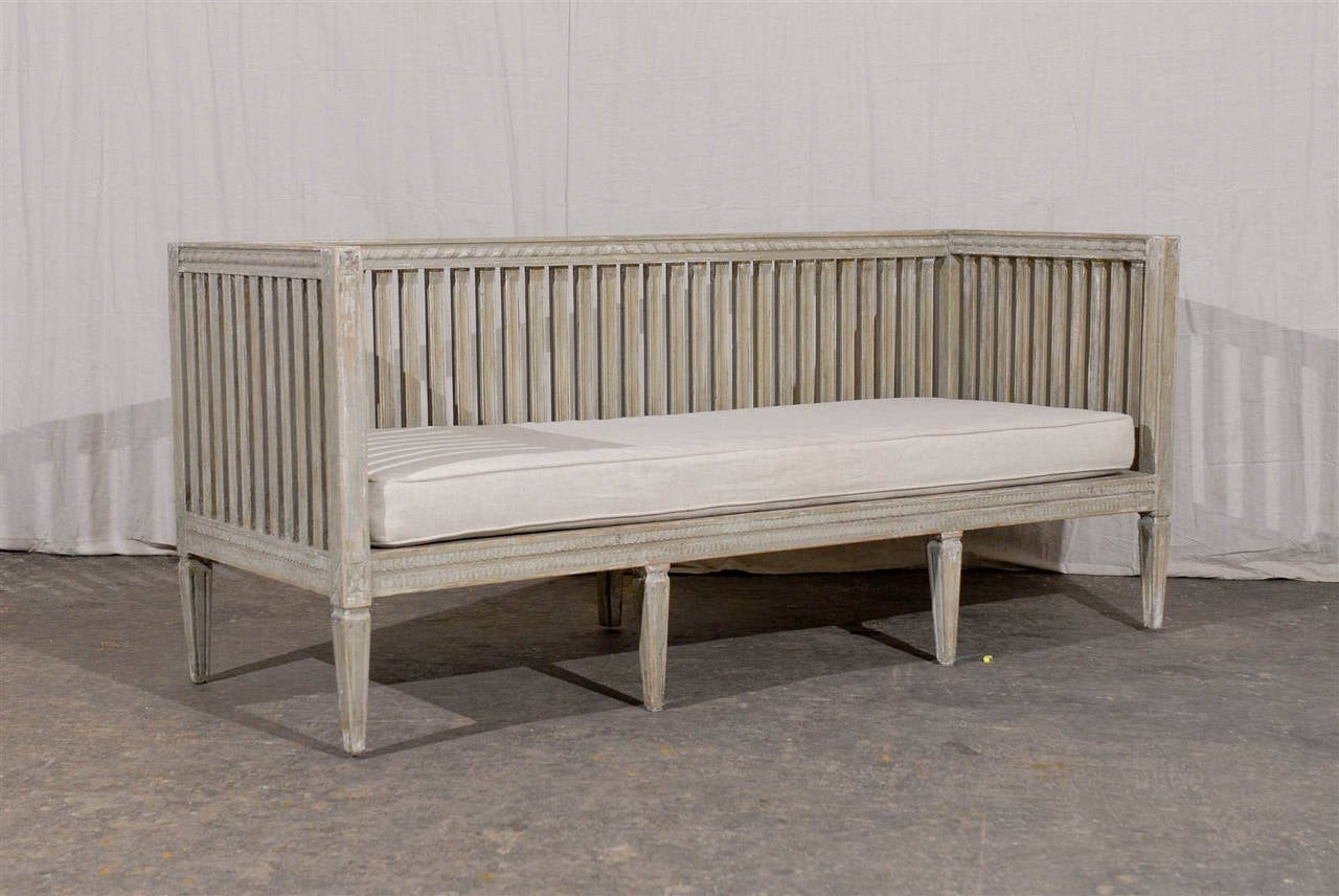 An early 19th century Swedish period Gustavian painted wood bench.

This painted wood bench comes with a newly made seat cushion and is made of a pierced back as well as pierced sides. The top rail and skirt are carved with delicate motifs and it